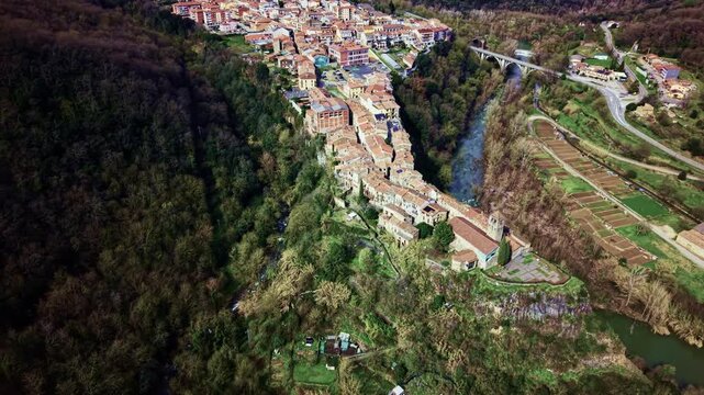 Drone descending over cliffside village of Castellfollit de la Roca in Catalonia.