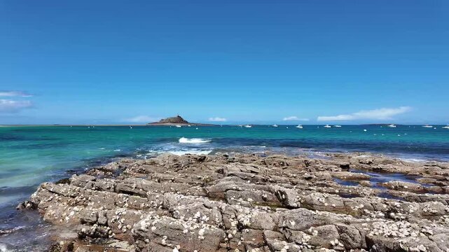 Saint-Michel beach with anchored boats and Ilot Saint-Michel island in Erquy, Brittany, France. 