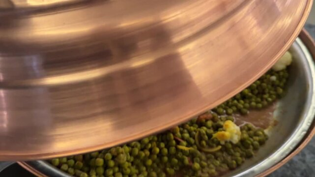 Small green mung beans with vegetables stir-fried in a pan, healthy vegan dish, nutritious and colorful.