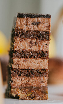 Close-up of decadent chocolate cake slice with multiple layers and filling