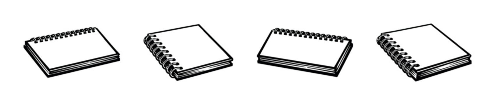 Collection of four blank spiral notebooks in different perspectives