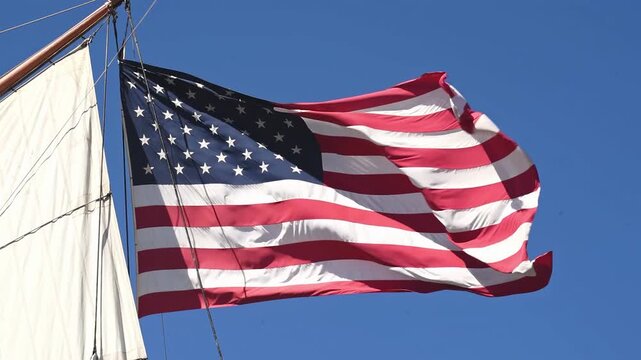 American flag waving in wind on sailboat mast video footage