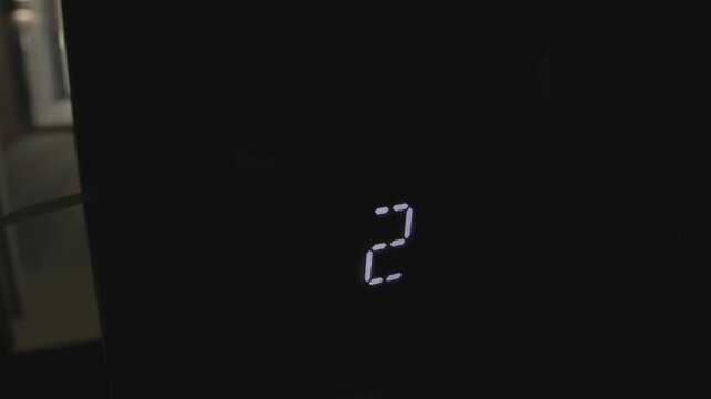 Electronic countdown display progressing from numeric two to segmented circular indicator across