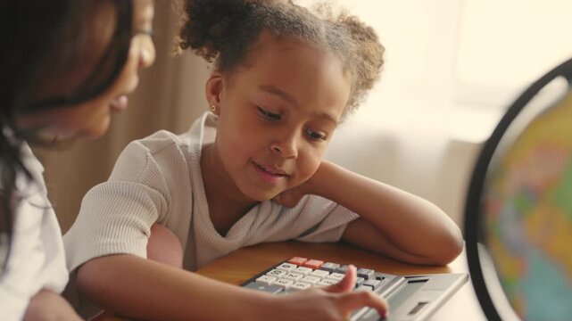 Portrait of smart six-years-old girl playing with calculator, mathematic lesson. Primary school student, fun education and homeschooling for little kids, arithmetic for elementary school students