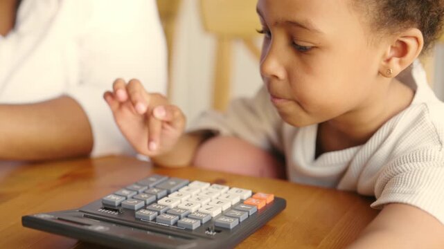 African american child girl counting on calculator, portrait at home or school. Preschooler studying mathematics, future accountant, cute little schoolgirl, student of primary school, adding numbers