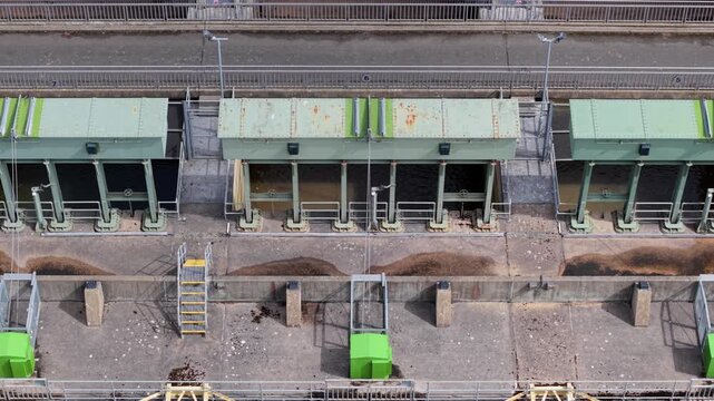 Aerial view of Tail Sluice showing the industrial gates and concrete infrastructure of the water management system in King's Lynn, England, United Kingdom.