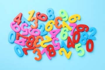 Fototapeta premium Colorful numbers on light blue background, flat lay