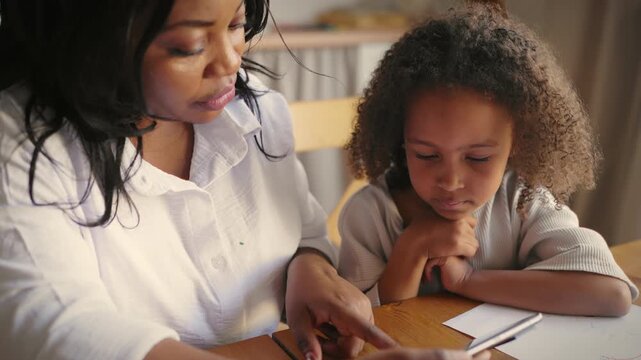 Tutor and little student girl viewing at smartphone screen and learning language. Modern technology for education and entertainment, children development and parenting, homeschooling for sick kids