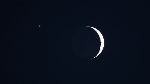 Close-up telescope shot of planetary alignment featuring moon Da Vinci glow and Venus