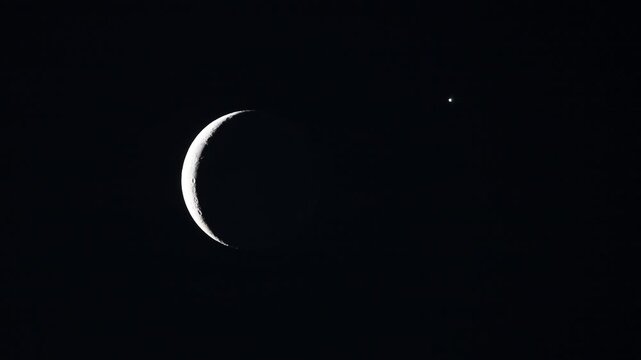 Telescope view of rare cosmic conjunction with crescent moon earthshine and planet Venus
