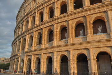 Naklejka premium Visitors Near the Colosseum at Golden Hour in Rome, Italy