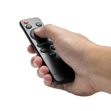 Close-up of hand holding black multi-function remote control, isolated on white background