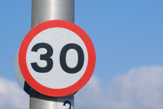 Sign Indicating 30 mph speed limit on road in UK