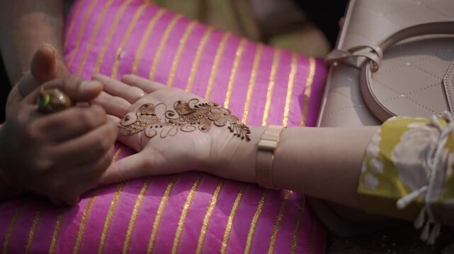 Mehndi Henna Applying on Bride Hands During Wedding Ceremony Showing Beautiful Traditional Art, Bridal Design, and Indian Cultural Celebration