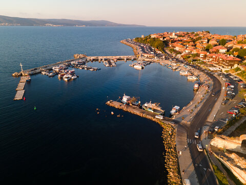 Aerial view of the marina with boats and yachts in old town of Nessebar, old church and houses, located in the Sunny Beach area of Bulgaria. Drone view from above. Summer holidays destination