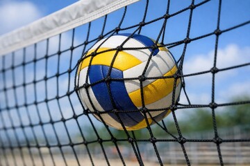 Obraz premium A volleyball ball stuck in a beach net