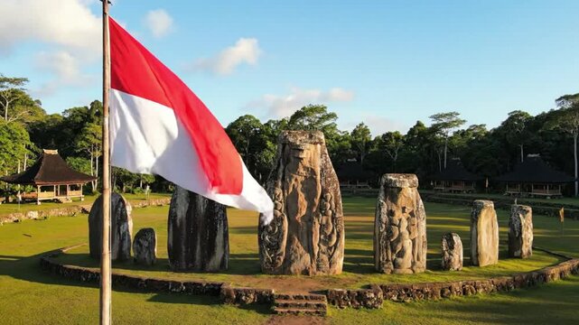 Indonesian Flag Waving at Ancient Megalithic Site in Sumba