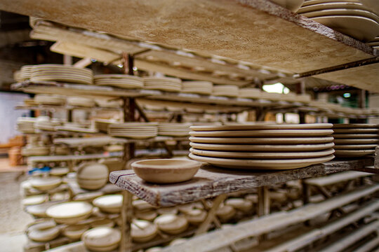 Ceramic plates being dried on shelves in a traditional ceramic warehouse in the city of Carmen de Vilboral, Colombia.