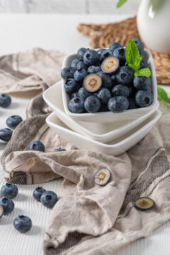 Fresh blueberries in white ceramic bowls