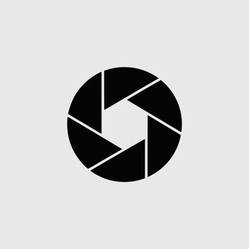 Black camera aperture icon on plain background.