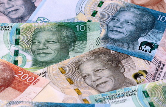 South African rand money bills pile on table. South Africa banknotes of ZAR currency close up.