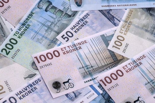Danish krone money bills pile on table. Denmark banknotes of DKK currency close up.