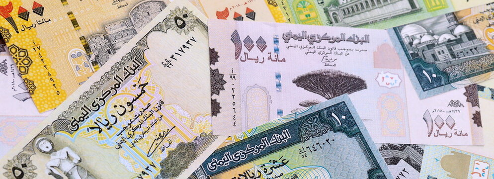 Yemeni rial money bills pile on table. Yemen banknotes of YER currency close up.