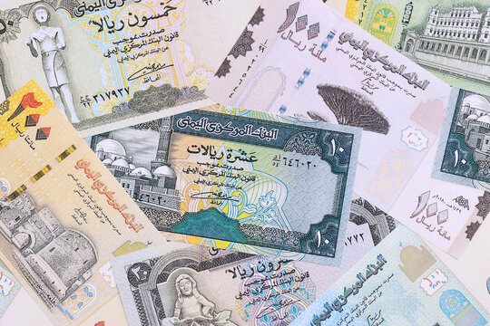 Yemeni rial money bills pile on table. Yemen banknotes of YER currency close up.