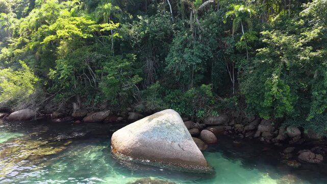 Large Rock in Clear Water Near a Tropical Coast
