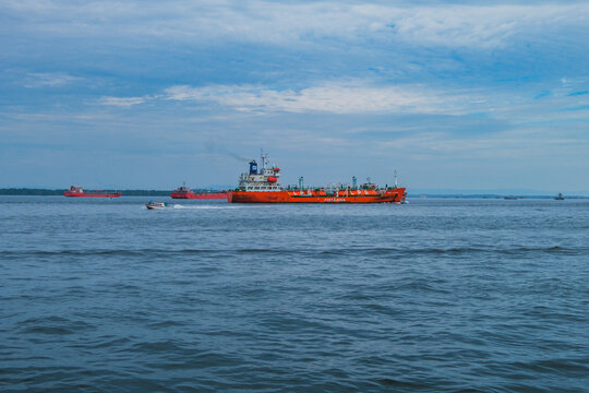 Pertamina LPG tanker ship and small speedboat sailing in Balikpapan bay