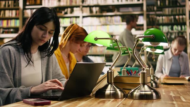 University student getting distracted by notification on phone while studying, loses focus on books, Phone message interrupting concentration during study time, digital distraction.