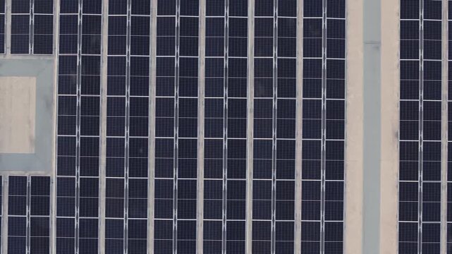 Aerial view of a large array of solar panels arranged in a grid pattern for renewable energy in Santo Domingo, Dominican Republic.
