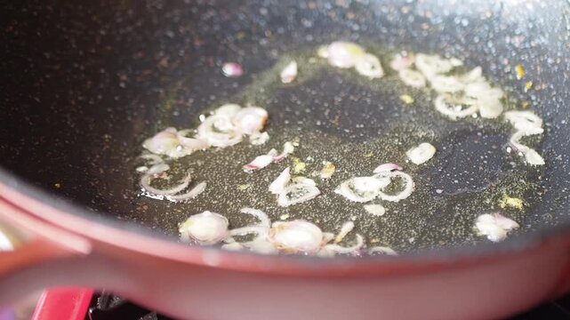 Saut?ing Sliced Shallots in Hot Oil in a Wok