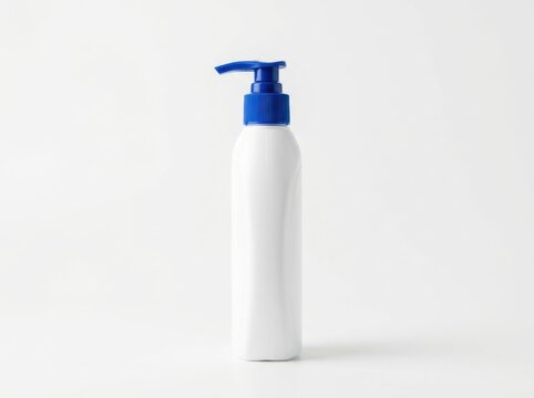 White plastic cosmetic bottle with a blue pump dispenser isolated on white background