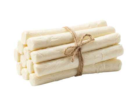 A bundle of white mozzarella cheese sticks tied with twine on a plain background.
