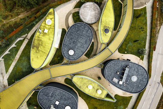 Bobadela, Portugal - 24 October 2025: Aerial view of the Museu do Azeite featuring unique leaf-shaped rooftops and modern architectural design surrounded by green spaces.