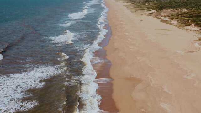 Serene Aerial Seascape: Playa Garzon Beach Waves and Colorful Shoreline Drone Shot