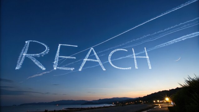 Inspirational Sky Writing of the Word Reach Over Serene Coastal Landscape at Dusk with Beautiful Gradient Colors