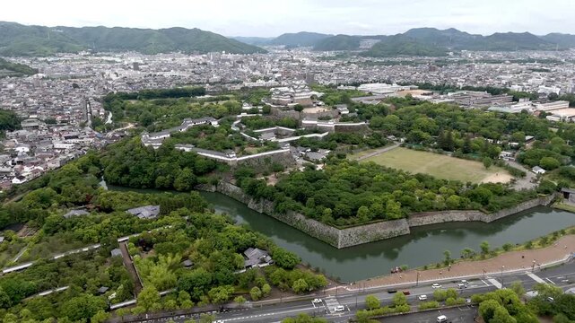 Aerial Flyaround of Himeji Castle with Moat and Historic Fortifications in Hyogo Japan