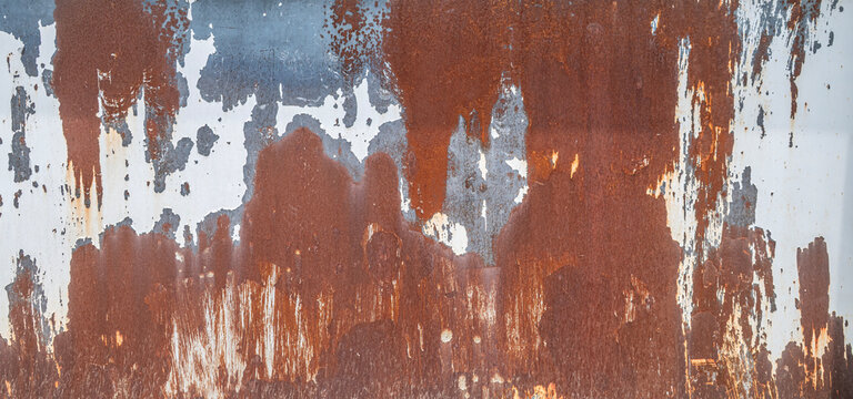 Weathered Industrial Rusted Metal Sheet Background, Distressed Metallic Surface with Flaking White Paint and Dark Orange Corrosion.