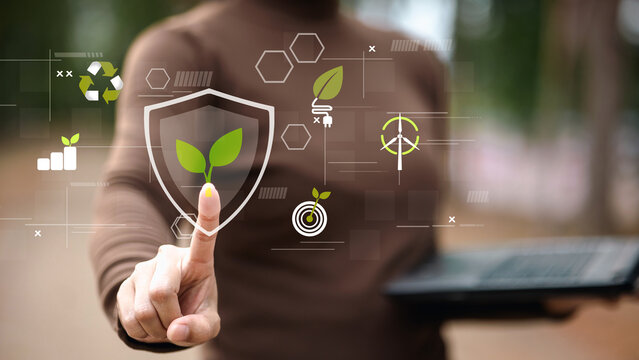 Businessman Touching Eco Shield Icon for ESG and Green Tech Stock Photo