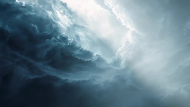 A captivating scene of swirling storm clouds and radiant light beams evokes feelings of mystery and anticipation. The contrast between shadow and brightness highlights nature's dynamic beauty