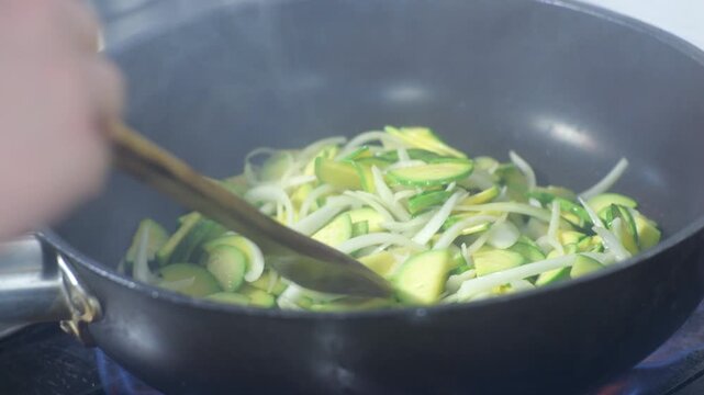 Stir fried zucchini Hobak bokkeum cooking in wok commercial kitchen Korean restaurant food 대한민국 한국 한식 호박볶음 주방 웍 야채볶음 식당 요리 조리 과정 가스불 화력 열기 김 모락모락 지글지글 셰프 손맛 비법 전통의 맛 감칠맛 깊은 풍미 고소한 향 반찬 채소 야채 신선식품 미식 식