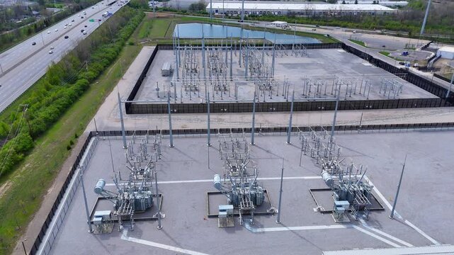 Electrical substation distributing power, showcasing energy grid and transportation highway