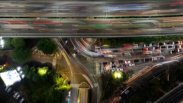 Cilandak, Indonesia - 10 April 2026: Aerial view of the Lebak Bulus intersection at night with vibrant light trails from traffic on the elevated highway and surrounding streets.