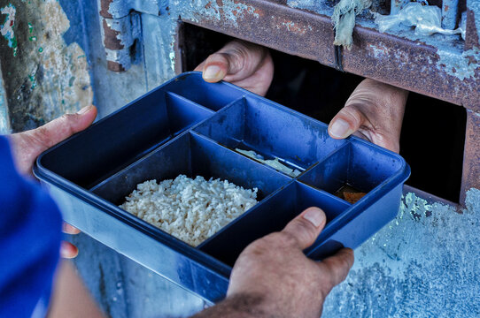 distribution of food rations to inmates inside their cells