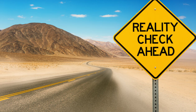 Desert highway landscape with a yellow road sign reading reality check ahead