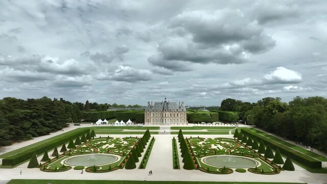 Sceaux Chateau and its grand formal gardens on a cloudy day