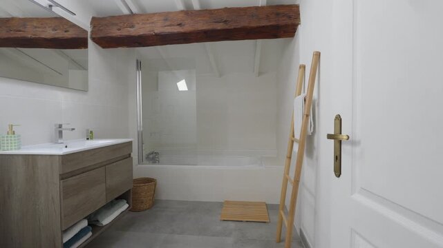 Bright minimalist bathroom, wood vanity, bamboo ladder, antique brass door handle.