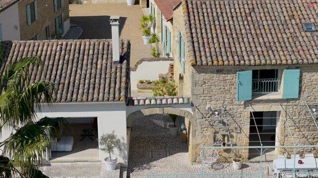 Overhead view of Mas Biaritz stone farmhouse and palm tree in South France